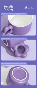 Detail of purple ceramic coffee mug with floral handle and non-slip bottom base