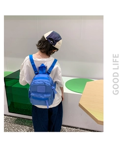 Back view of a blue lightweight preschool backpack with wide straps on a young child