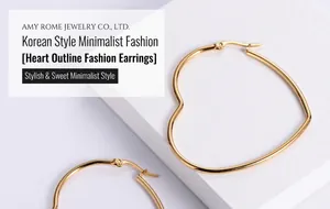 Detailed close-up of golden heart-shaped hoop earrings with wire design on white stone