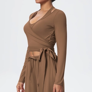 Detail of coffee brown yoga set featuring wrap-around tie top and high-waist drawstring pants