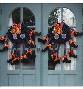Detail of Halloween spider door wreath with purple striped legs and witch boots