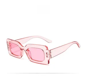 Detail shot of pink translucent rectangular sunglasses frame with smooth finish