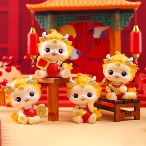 Detailed view of four Chinese New Year dragon figurines with lucky red and gold motifs