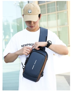 Detail of navy blue anti-theft sling bag with security combination lock and USB charging port