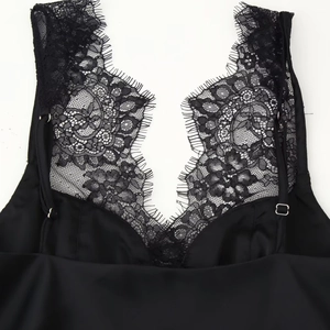 Black satin camisole top with delicate lace trim and adjustable straps for women