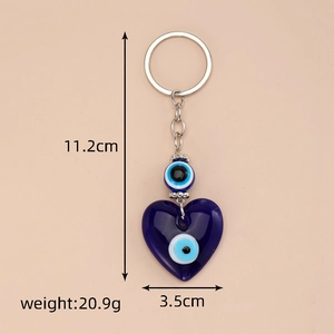 Detailed view of blue heart evil eye keychain with alloy rings and measurement labels