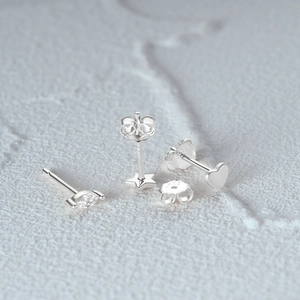 Macro detail of S925 sterling silver star and heart studs with clear marquise zircon
