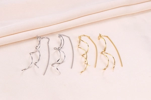 Detailed view of long S925 silver spiral earrings in gold and silver finishes