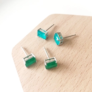 Detail of rectangular zircon earrings in green and emerald tones with S925 silver studs