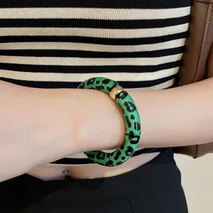 Vintage green leopard print resin bracelet with gold metal segments for a trendy look