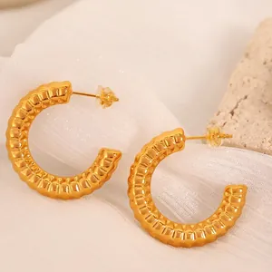 Minimalist gold C-shaped striped hoop earrings with textured ripple design for women