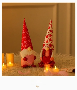 Detail of plush Valentine gnomes with heart accents and festive LED candle background