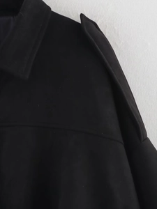 Detail of black faux suede bomber jacket showing collar, epaulettes and matte texture