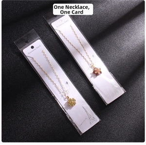 Detailed macro view of rotating clover and flower pendants in stainless steel