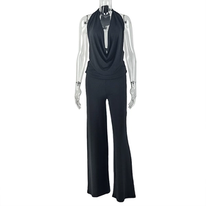 Detail of black halter neck jumpsuit featuring a draped cowl neckline and wide-leg design