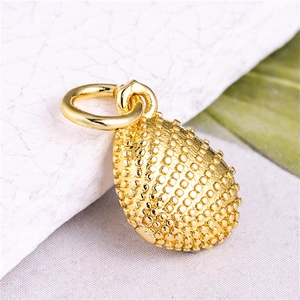 Macro shot of gold teardrop pendant with detailed pebble texture and hanging ring