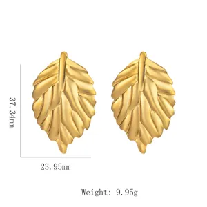 Detail view of gold leaf earrings with vein texture including size and weight specs