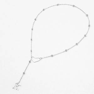 Detail of silver beaded chain with hollow heart and hanging letter K pendant necklace