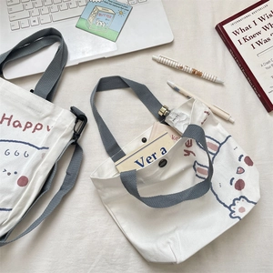 Detail of cute bunny canvas tote bag showing top snap closure and shoulder strap design