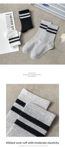 Detail of high-elasticity ribbed cuffs on striped cotton socks in black white and grey colors