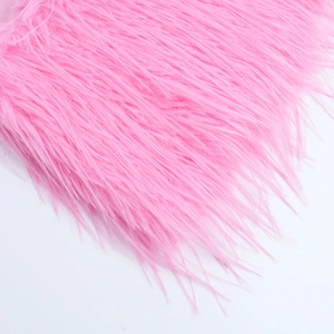 Close-up of fluffy pink faux fur texture and long fibers on a party dress detail