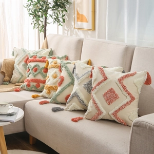 Set of five tufted cotton linen pillow covers with geometric patterns and tassels