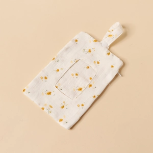 Detailed view of floral cotton gauze baby crib organizer with snap strap and zipper
