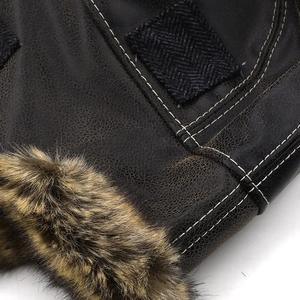 Macro detail of winter pilot hat featuring vintage faux leather, fur trim and white stitching