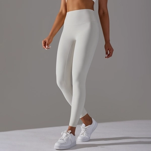 Close-up of the wide high-waisted waistband on ivory brushed yoga leggings for tummy control