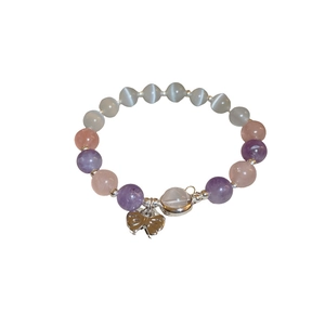 Beaded bracelet with pink purple cat eye stones and a silver bow pendant for women