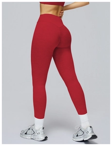 Macro detail of red high-waisted leggings showing seamless compression fabric texture