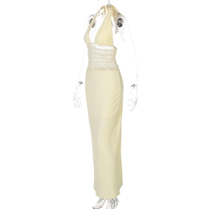 Detailed view of yellow halter dress featuring waist sheer mesh patchwork and pleated fabric