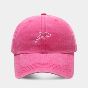 Detailed close-up of rose pink washed cotton baseball cap with dolphin embroidery