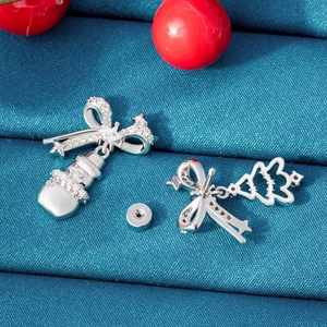 Christmas snowman and tree stud earrings in silver steel on blue fabric background
