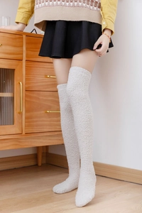 Detail of cream coral fleece over-the-knee socks showing soft plush warmth and texture