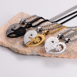 Three pairs of interlocking heart and key necklaces in gold, silver, and black stainless steel
