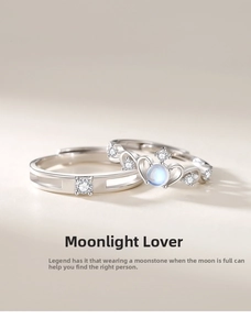 Macro detail of silver moonstone couple rings with crown design and simple band