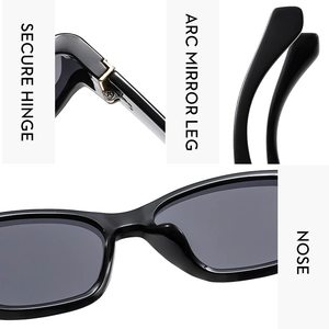Detail view of reinforced hinges, curved legs, and nose pads of black fashion sunglasses