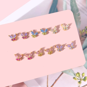 Macro detail of butterfly earrings with colorful zircon stones and gold plating