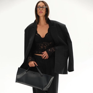 Chic women's sheer black lace V-neck top styled with a dark grey oversized blazer set
