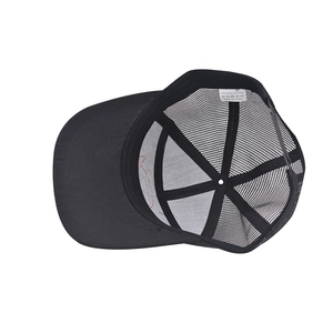 Detail of internal structure with 100% polyester wash label on black mesh trucker cap