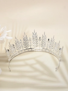 Detail shot of vintage silver bridal tiara with intricate metallic leaf design