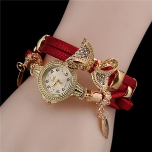 Close-up of women quartz watch with red braided strap and sparkling rhinestone bow detail