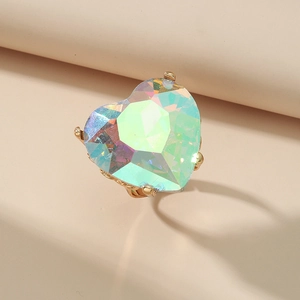 Golden ring with a large heart-shaped crystal featuring vibrant blue-green hues