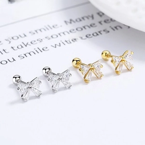 Detailed view of 925 silver bow earrings with zircons and secure screw backings