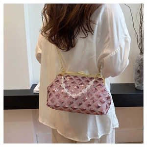 Detailed view of pink sequined shell bag with pearl handle and golden chain strap