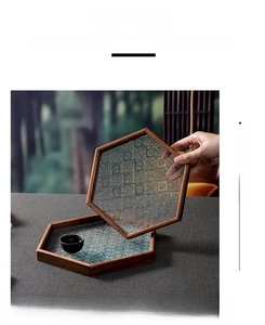 Macro detail of the hexagonal begonia embossed glass tray and solid wood frame texture