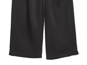 Detailed view of wide-leg satin trousers hemline and professional stitching finish