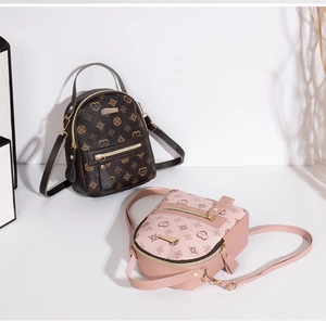 Detail view of mini floral patterned backpacks in brown and pink synthetic leather