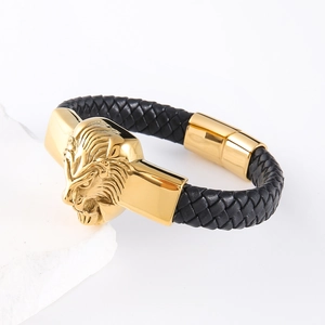 Men's braided leather bracelet with a gold lion head charm and stainless steel buckle